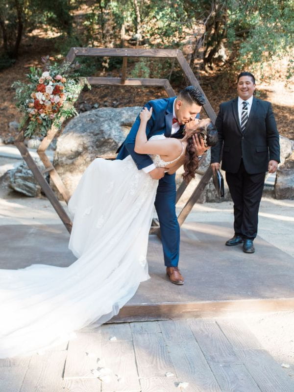 Couple sharing first kiss at outdoor wedding ceremony officiated by Gabriel Hernandez in the San Gabriel Valley